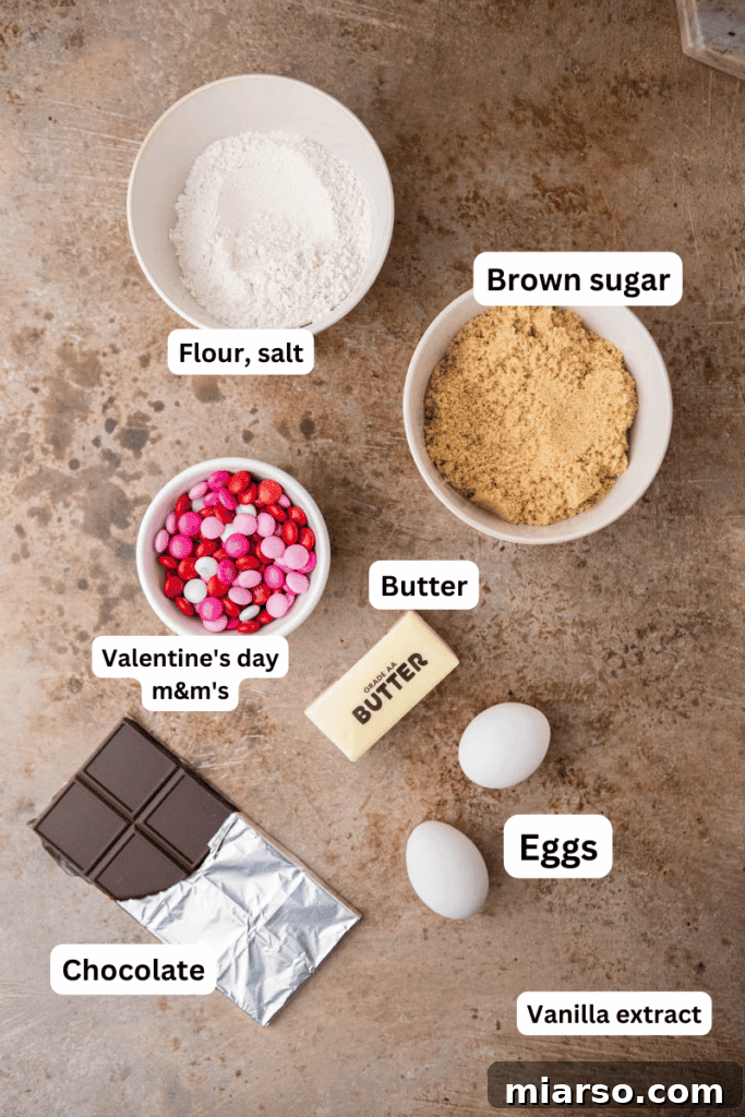 A selection of essential ingredients for M&M blondies laid out on a kitchen counter