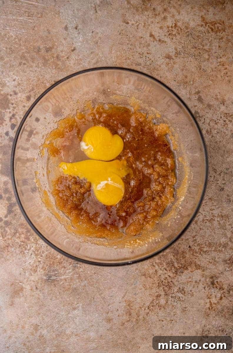 Wet ingredients being mixed in a bowl for blondies, showing a smooth, creamy texture