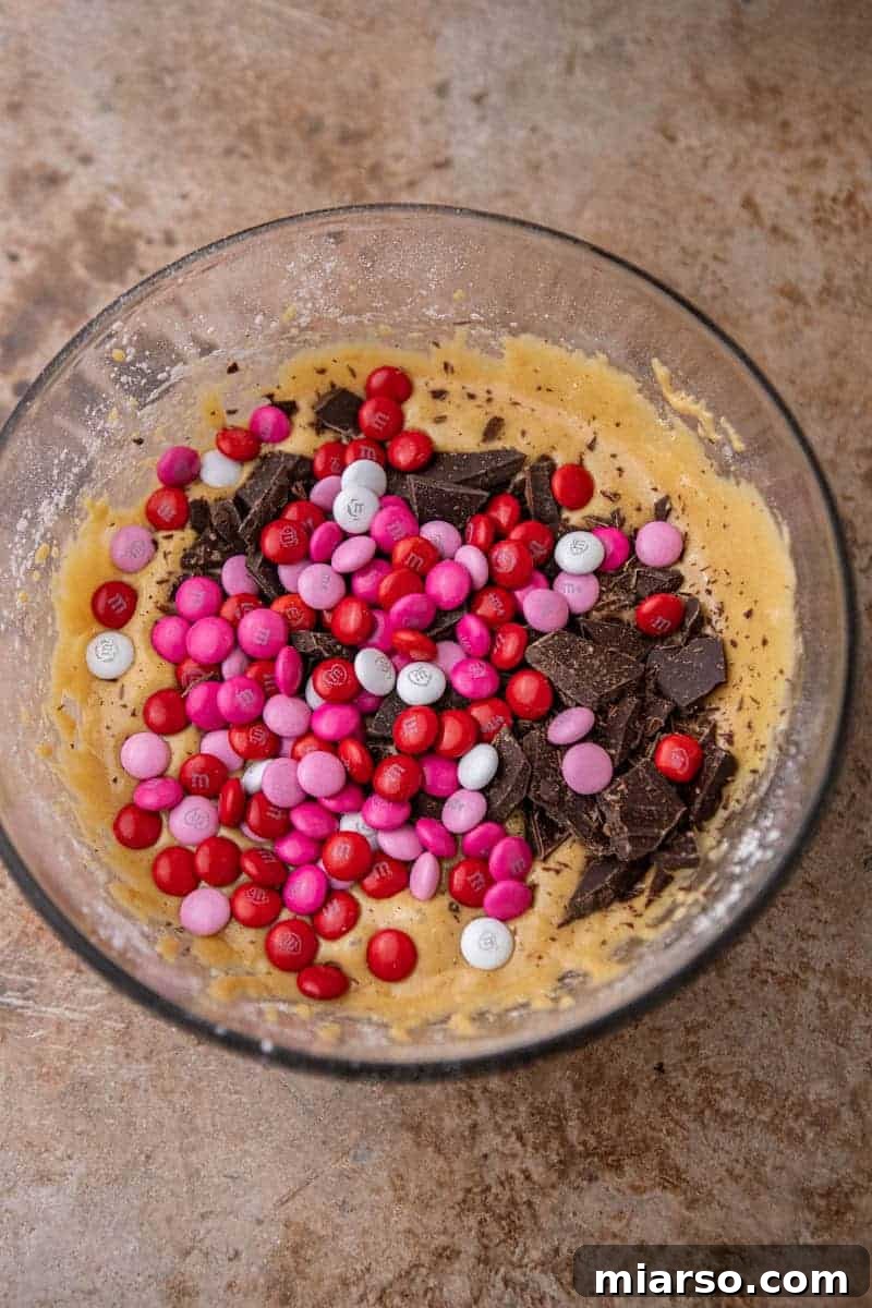 Blondie batter with M&M's and chocolate chunks ready for transfer to a baking pan