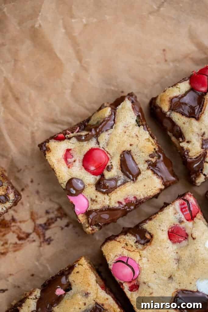 A tray of perfectly sliced Valentine's Day M&M's blondies ready to be served