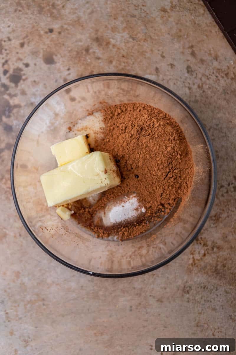 Melted butter, oil, and sugars in a bowl, ready to be mixed.
