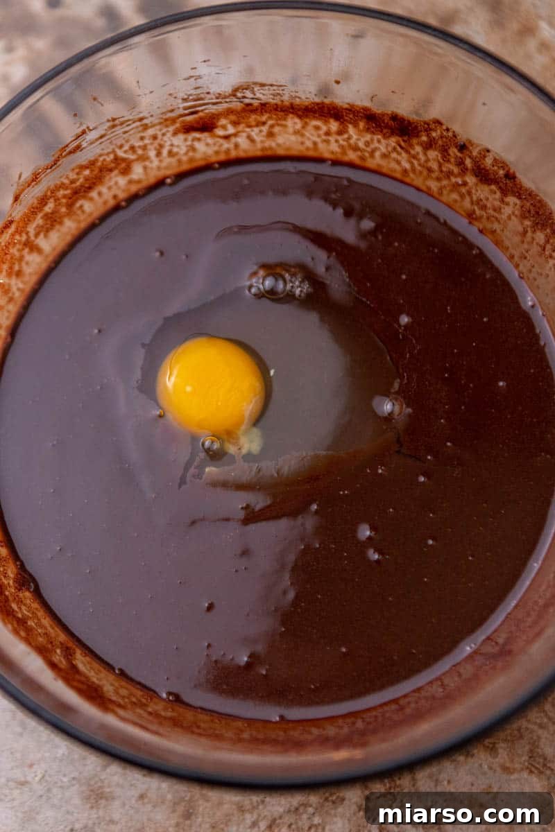 Mixing the wet ingredients for the fudgy skillet brownie.