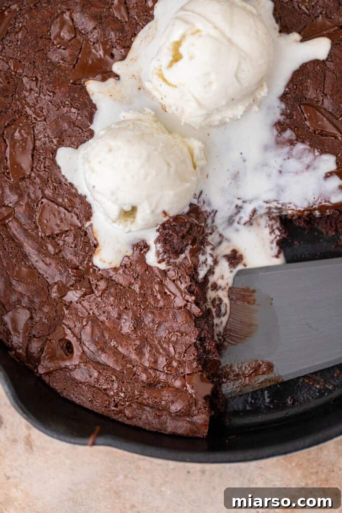 A close-up shot of a rich, fudgy skillet brownie with a perfect crinkly top.