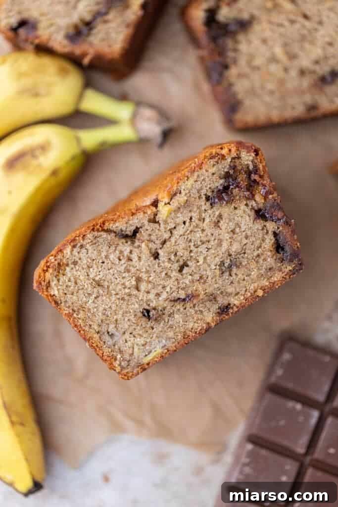 A freshly baked, golden-brown loaf of eggless banana bread on a cooling rack