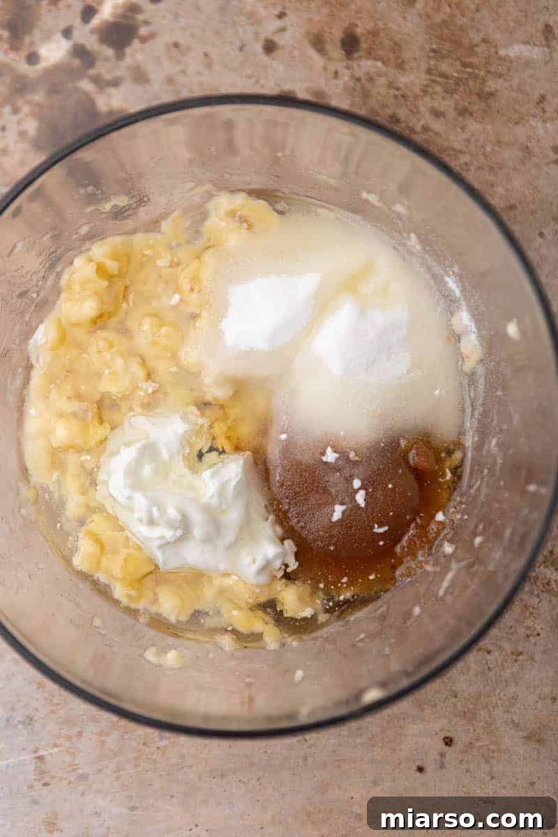 Wet ingredients for banana bread mixed in a bowl