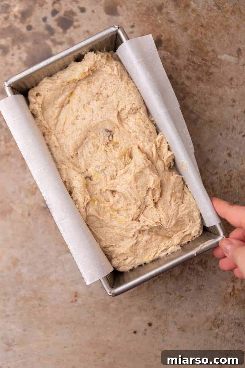 Banana bread batter poured into a loaf pan, ready for baking