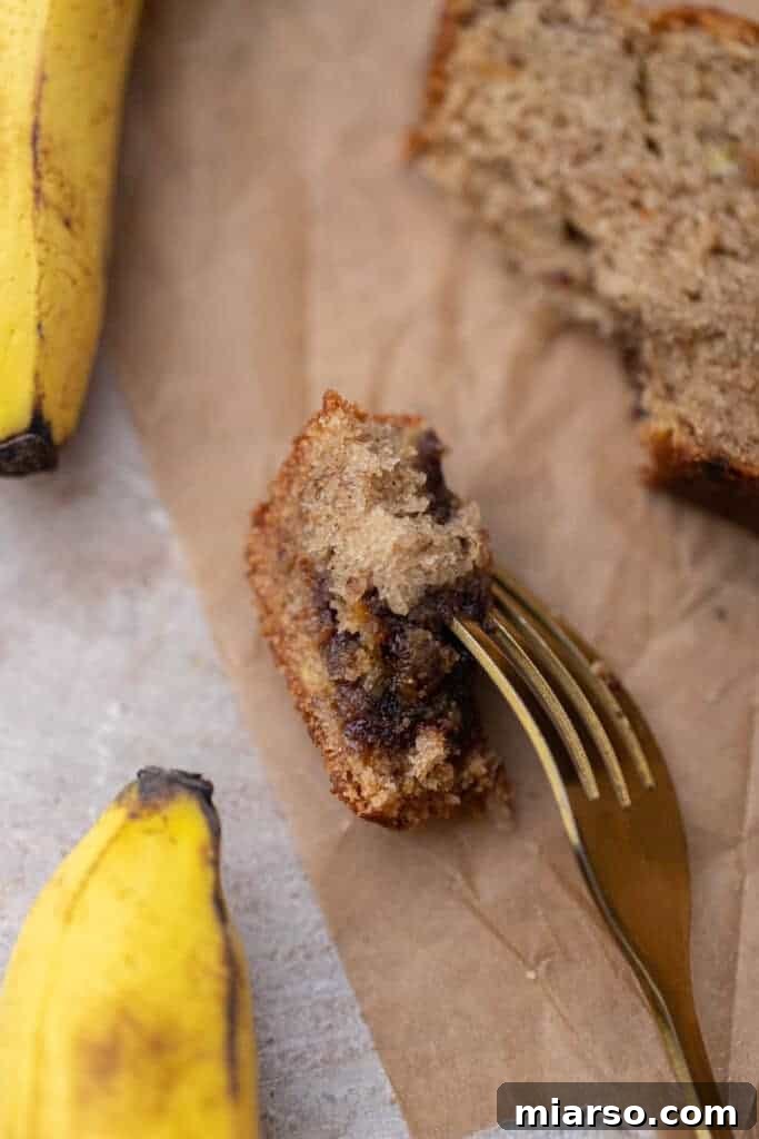 A bite taken out of a slice of moist eggless banana bread