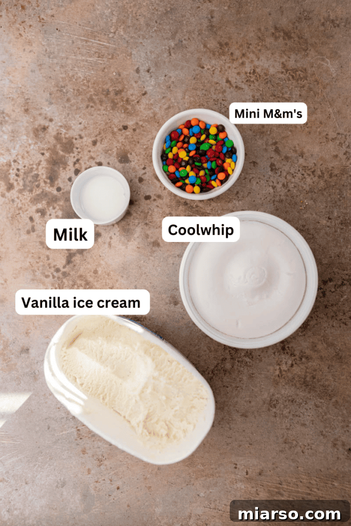Ingredients for a homemade M&M's McFlurry laid out on a kitchen counter.