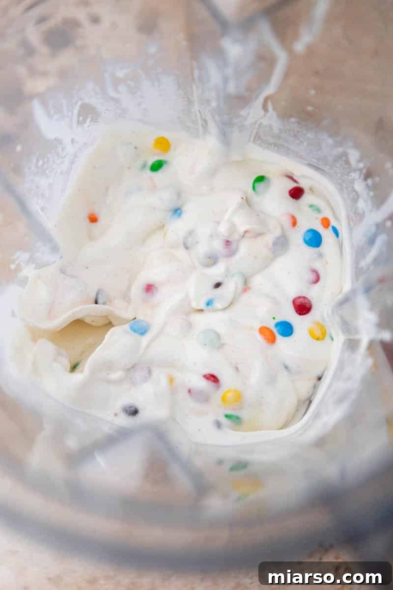 A McDonald's M&M McFlurry copycat being prepared in a blender cup.