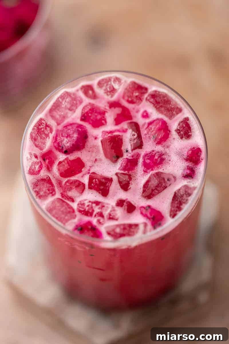 Close-up of the finished Starbucks Mango Dragonfruit Refresher in a glass