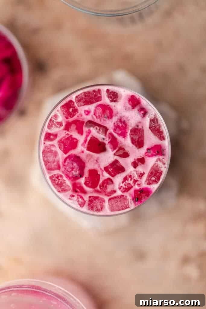 Overhead shot of two Starbucks Mango Dragonfruit Refreshers with dragonfruit pieces