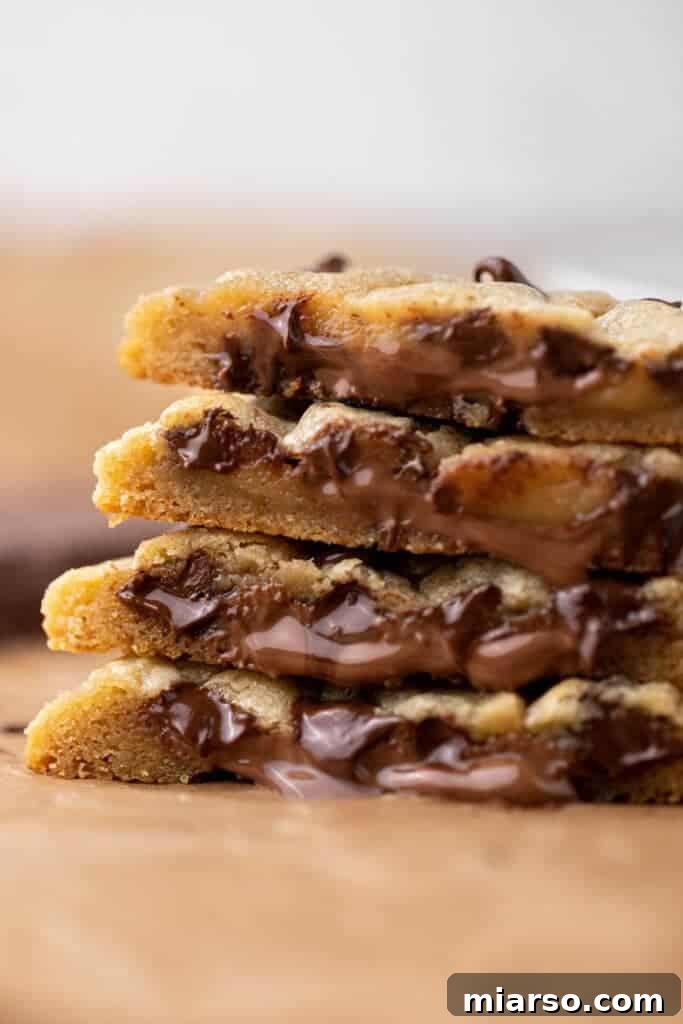 Irresistible chocolate stuffed chocolate chip cookies cooling on a rack