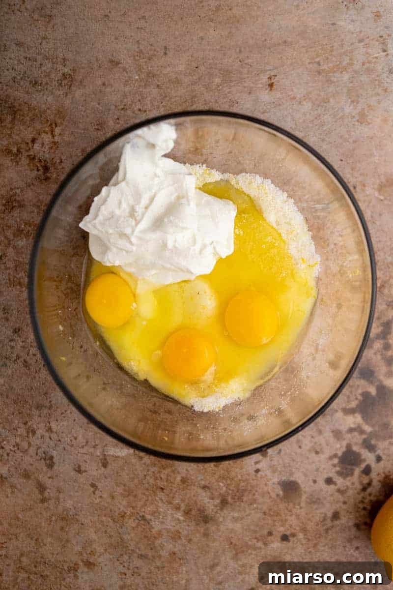 Wet ingredients for the lemon loaf being mixed in a bowl.