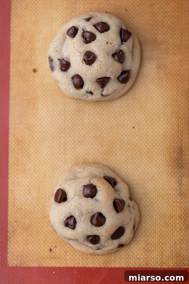 Oreo Stuffed Chocolate Chip Cookies Made Simple 11 A batch of thick, golden-brown Oreo stuffed chocolate cookies fresh out of the oven, showcasing their irresistible texture.