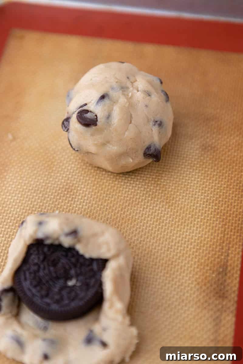 Oreo Stuffed Chocolate Chip Cookies Made Simple 9 The chocolate chip cookie dough carefully folded over an Oreo, completely encasing it.