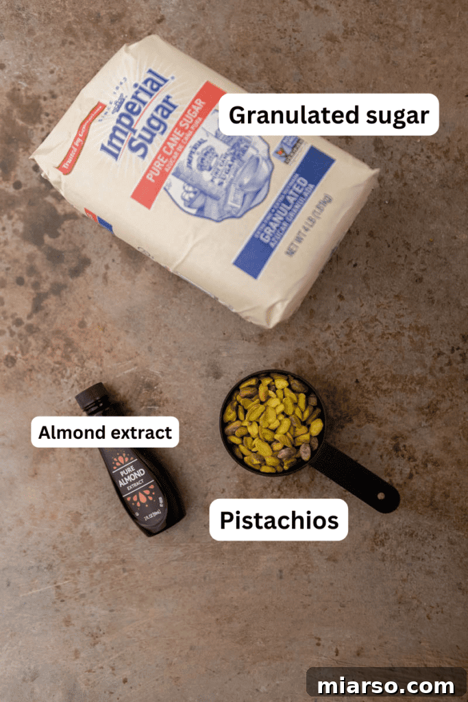 Starbucks Pistachio Syrup: Your Coffee's Delicious Upgrade 3 Ingredients laid out on a kitchen counter for making pistachio syrup, including sugar, water, pistachios, and almond extract