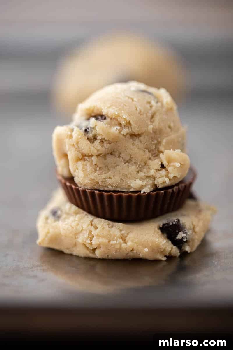 Quick Reese Peanut Butter Cup Chocolate Chip Cookies 8 Flattened cookie dough with a Reese's cup placed in the center, ready to be sealed.