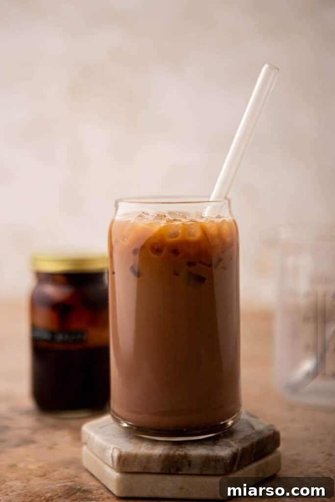 A refreshing iced mocha latte served in a tall glass, garnished with a straw, perfect for a hot day.