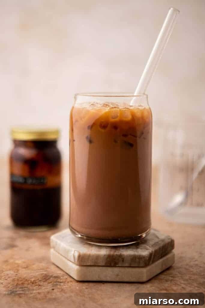 A finished iced mocha latte, topped with whipped cream and chocolate drizzle, ready to be enjoyed.