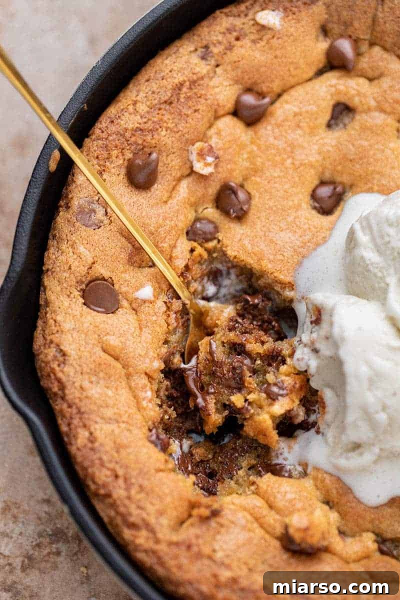 Gooey Skillet Chocolate Chip Pizookie 9 Delicious chocolate chip skillet cookie recipe presentation, showcasing the warm cookie in its pan.
