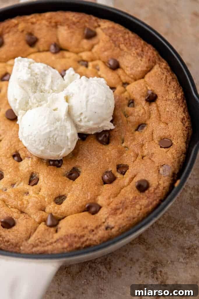 Gooey Skillet Chocolate Chip Pizookie 10 A warm pizookie cookie, fresh from the skillet, generously topped with multiple scoops of melting vanilla ice cream and a drizzle of caramel sauce.