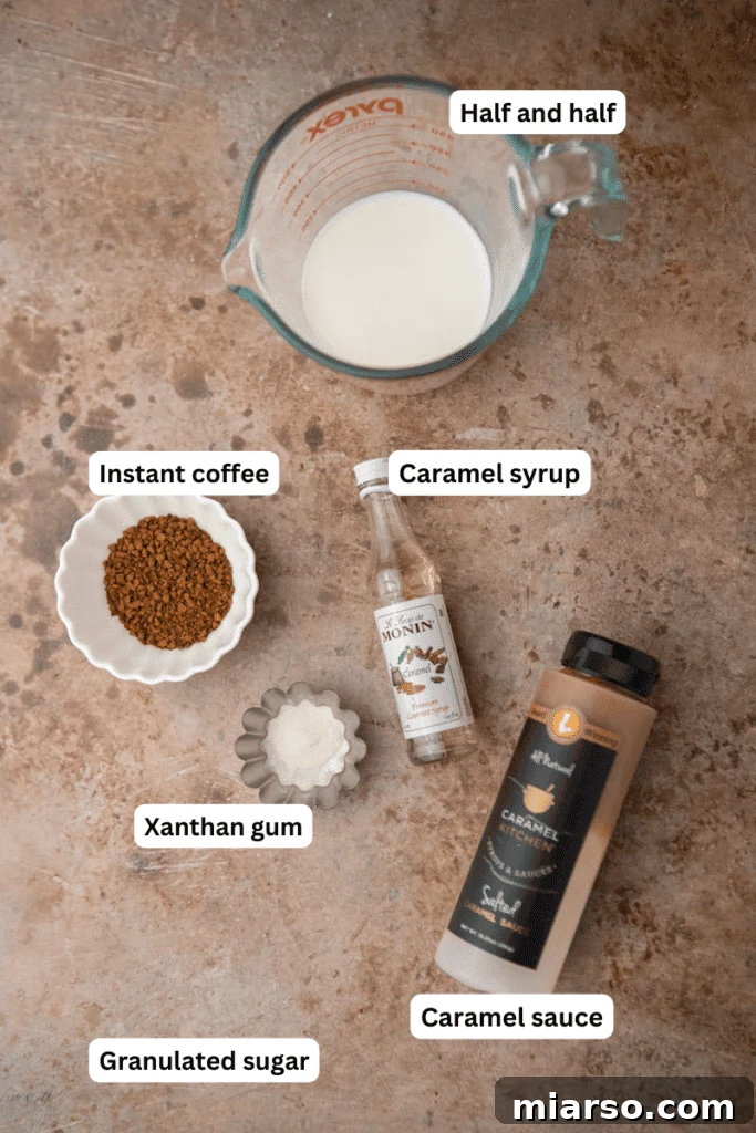 Ingredients for homemade McDonald’s caramel frappe including ice, coffee, caramel syrup, and milk in a blender before blending