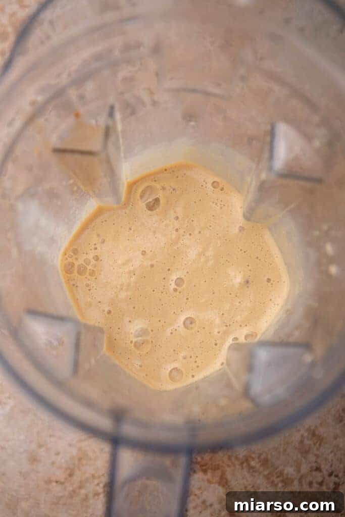 Smooth blended caramel frappe mixture in a blender, ready to pour
