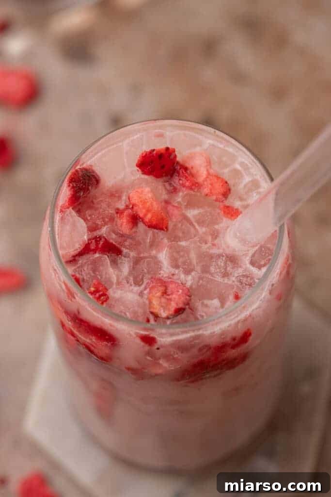 Overhead shot of Starbucks pink drink with strawberries