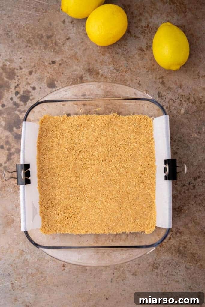 Pressed graham cracker crust in a baking pan