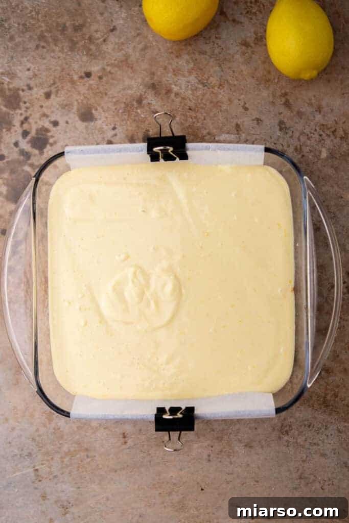 Lemon bar filling poured over the graham cracker crust