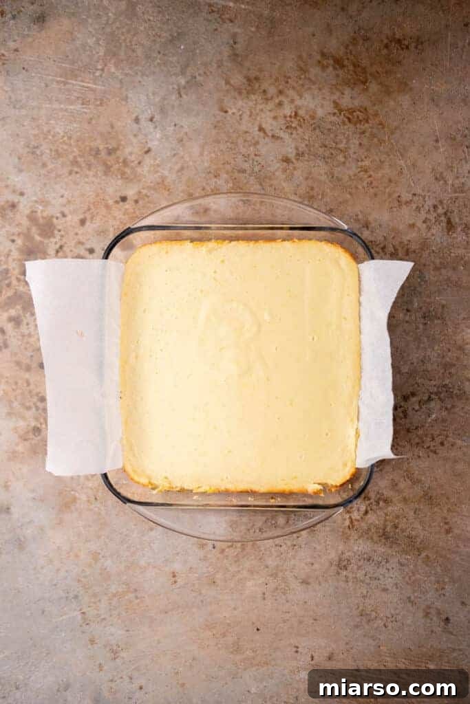 Freshly baked lemon bars with graham cracker crust in a pan