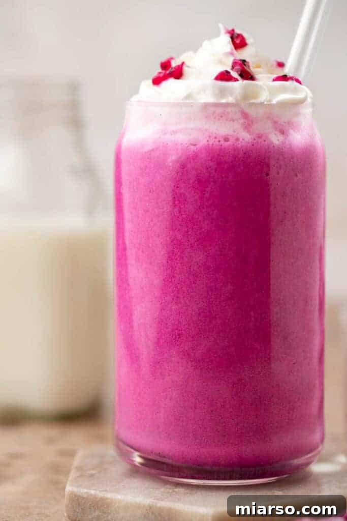 Starbucks Barbie Frappuccino, a beautiful pink blended beverage with whipped cream.