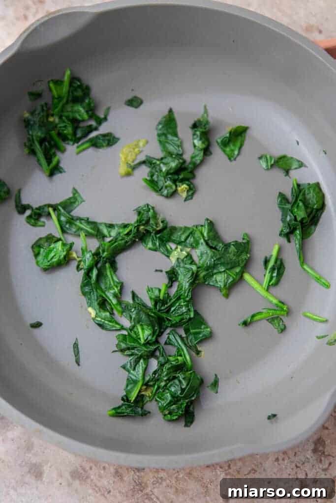 Spinach cooked in a pan for the wrap