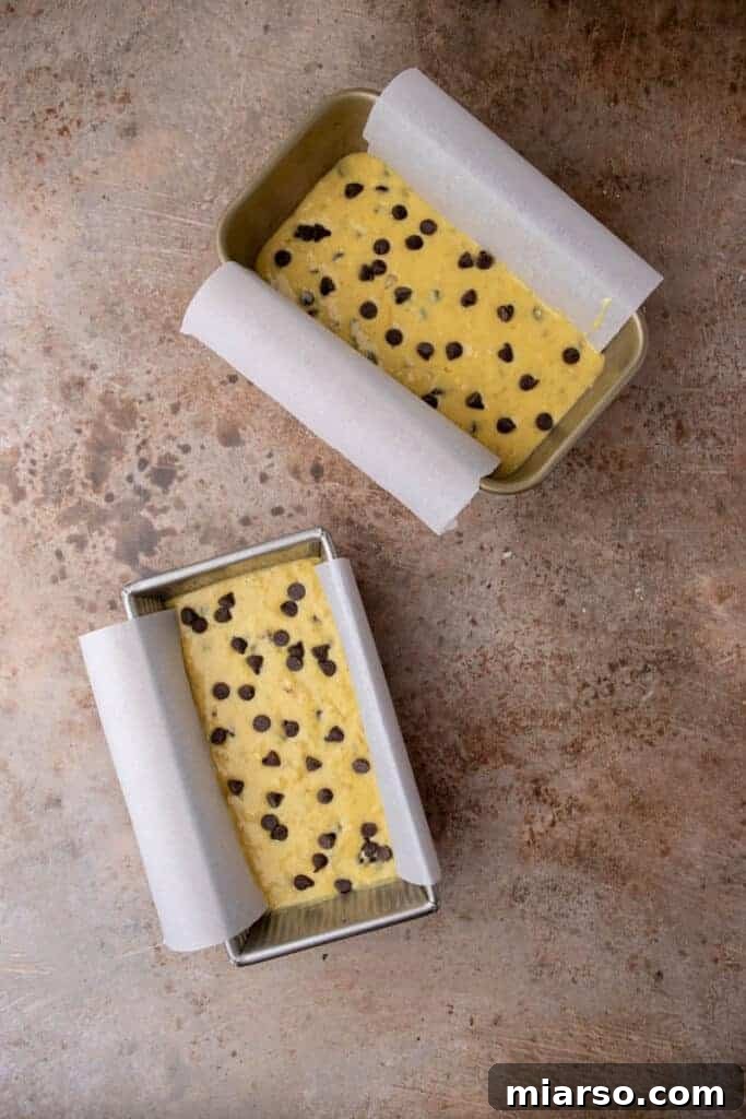 Banana bread batter poured into a prepared loaf pan