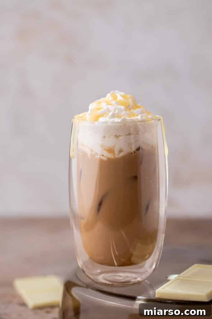 Close-up of a finished Starbucks white chocolate mocha latte with whipped cream