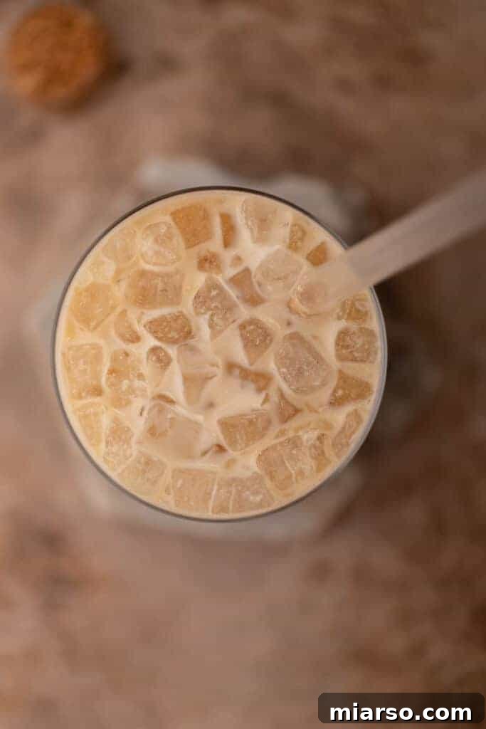 Overhead shot of a beautifully prepared white chocolate mocha latte with whipped cream and a spoon