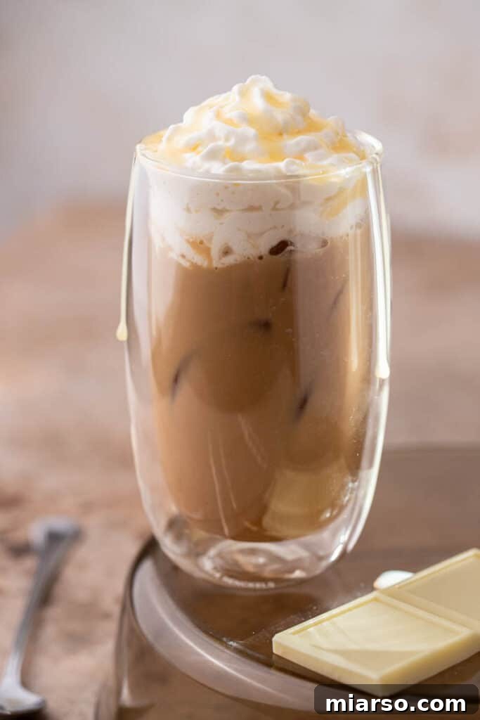Starbucks white chocolate mocha latte with whipped cream and a delicate drizzle.