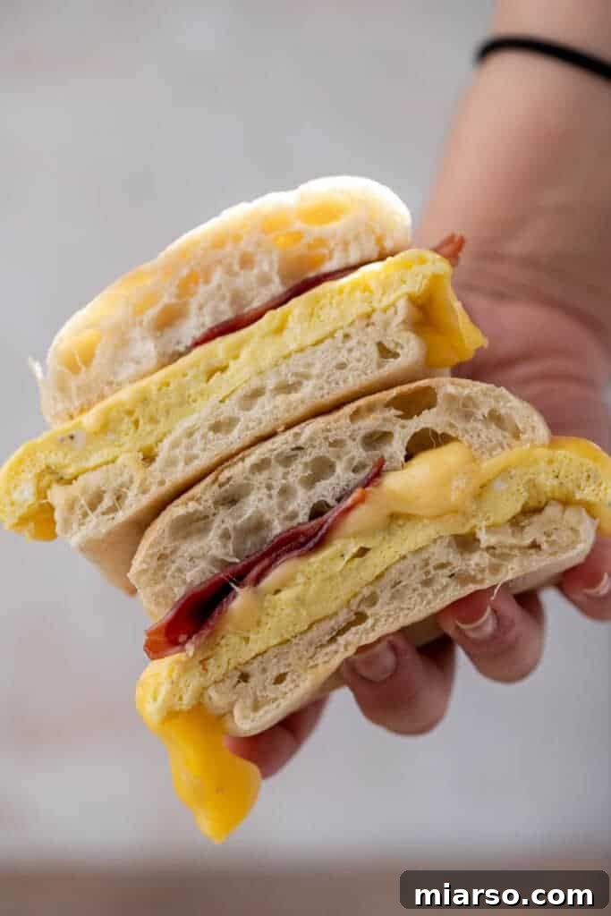 Starbucks Bacon Gouda: The Perfect Morning Indulgence 2 Hand holding Starbucks bacon egg and cheese sandwich
