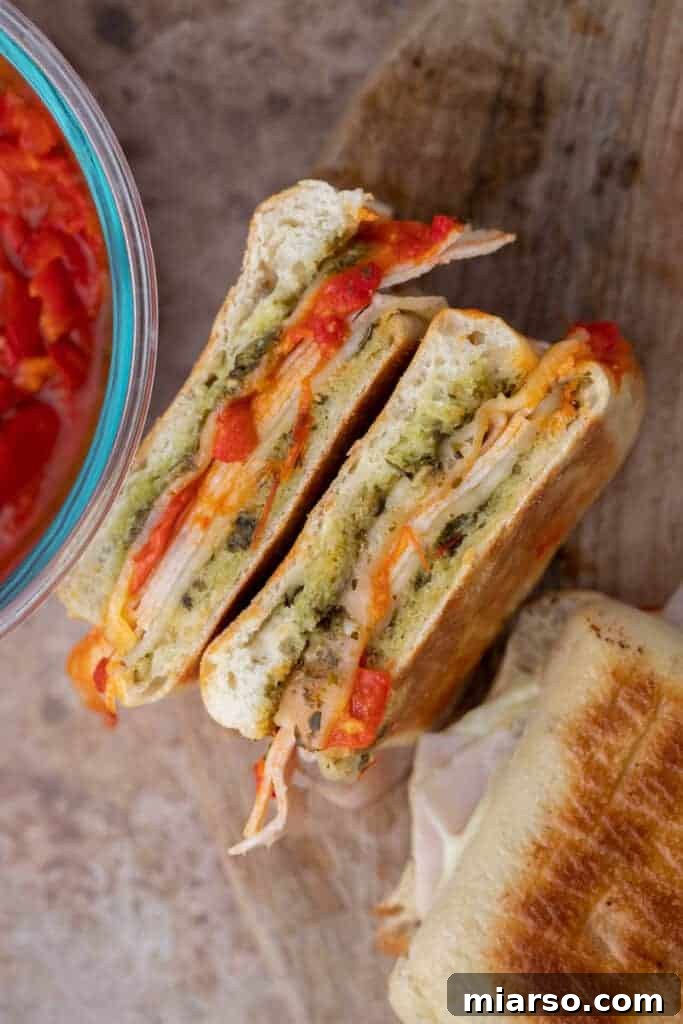 starbucks turkey provolone pesto panini being pressed on a grill