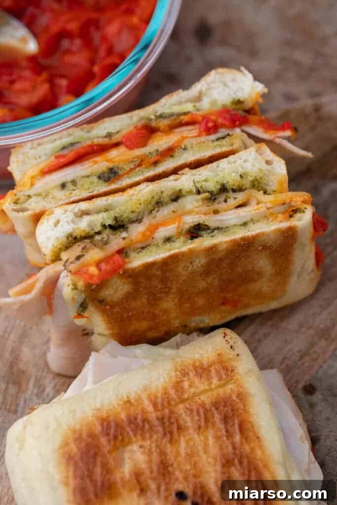Starbucks turkey pesto sandwich sliced in half, showing internal layers