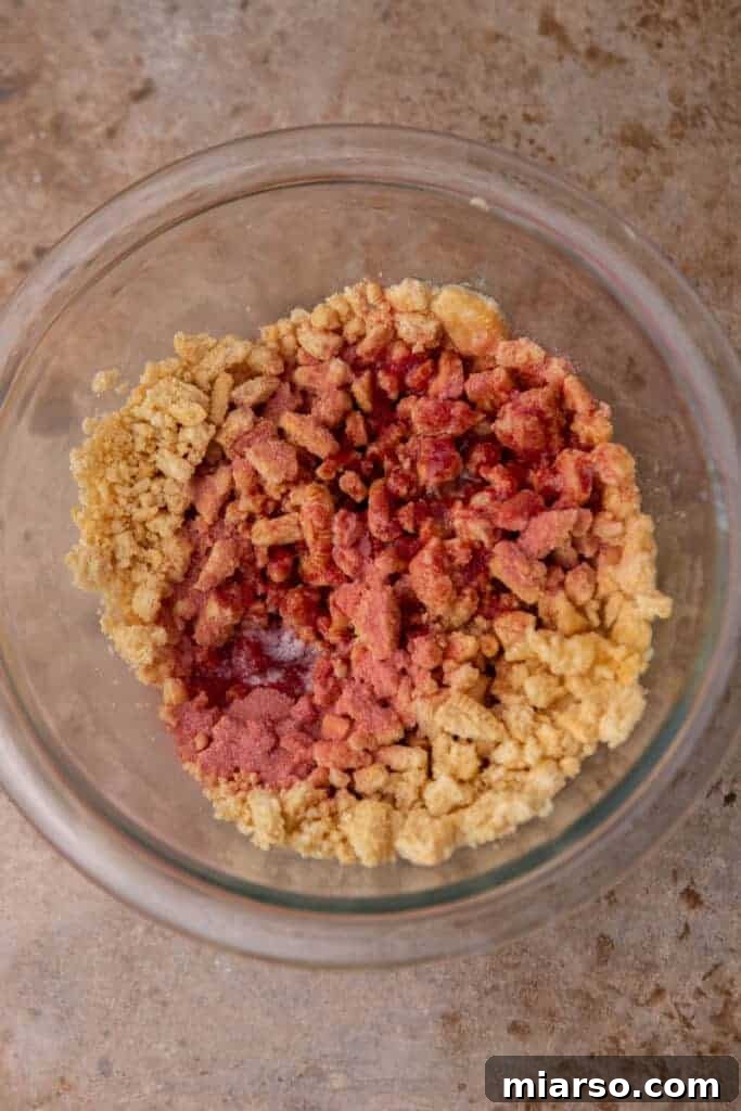 Heavenly Strawberry Shortcake McFlurry 5 Strawberry shortcake crunch mixture in a bowl before baking, showing the vibrant jello powder and butter.