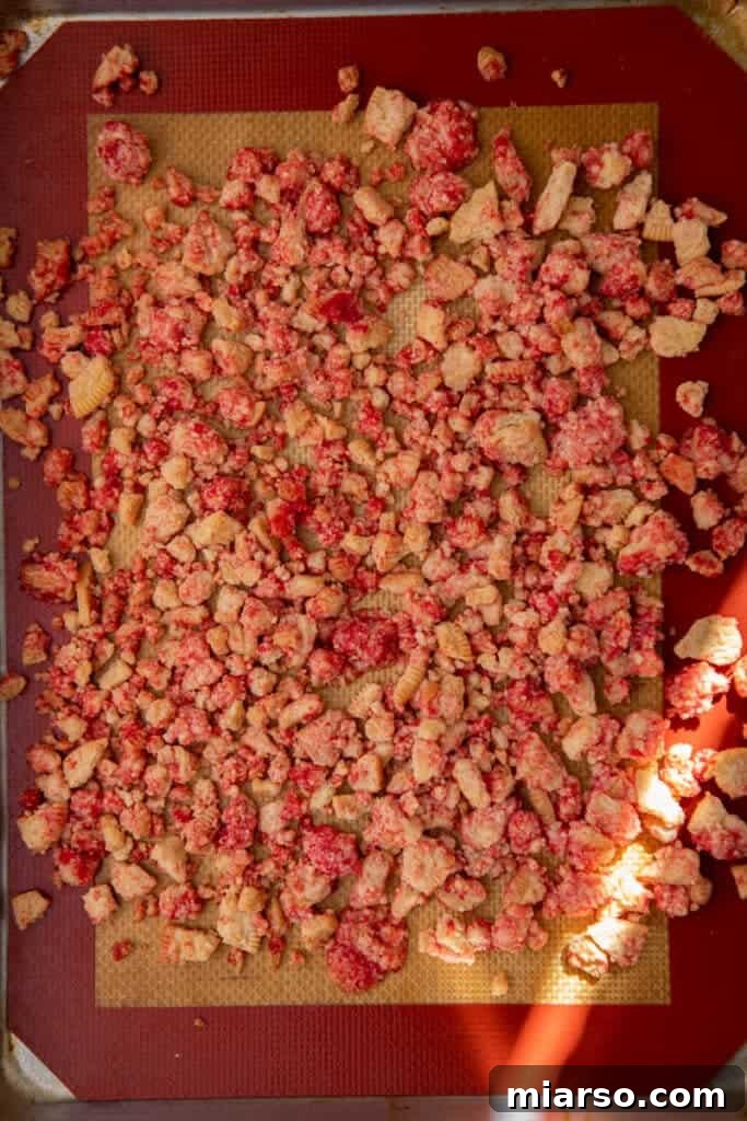 Heavenly Strawberry Shortcake McFlurry 7 Strawberry shortcake crunch spread evenly on a parchment-lined baking sheet, ready for the oven.