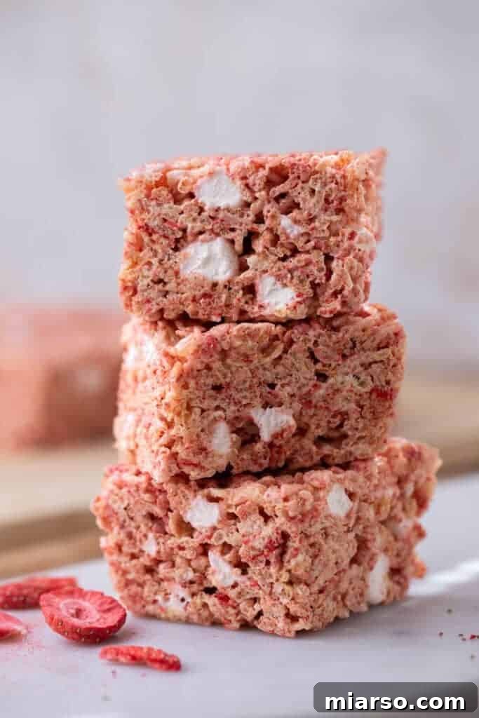 Strawberry Rice Krispies Treats, showcasing their vibrant pink color and chewy texture.
