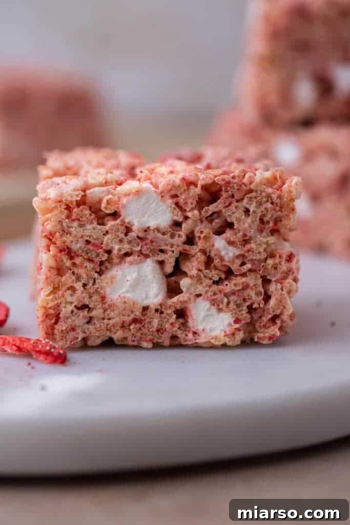 Close-up of a single slice of strawberry rice krispies treat.