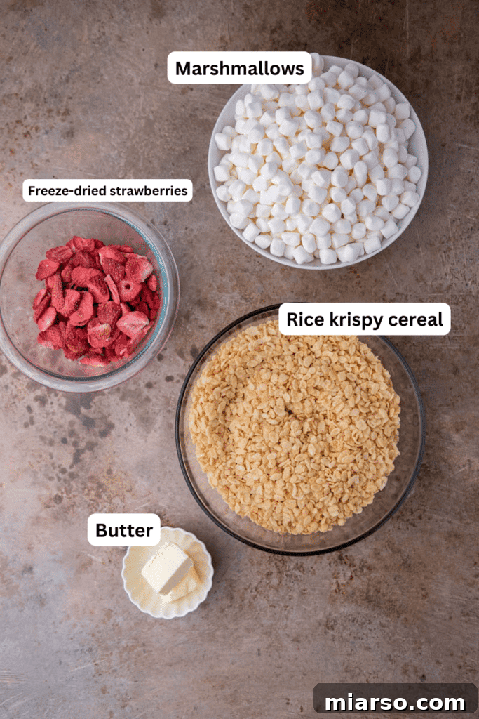 Ingredients for strawberry rice krispies treats laid out on a kitchen counter.