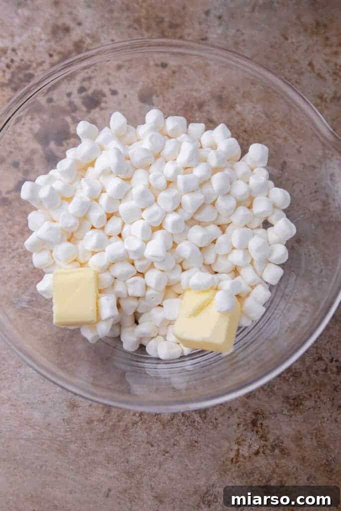 Marshmallows and butter melting in a bowl, showing the initial stage.