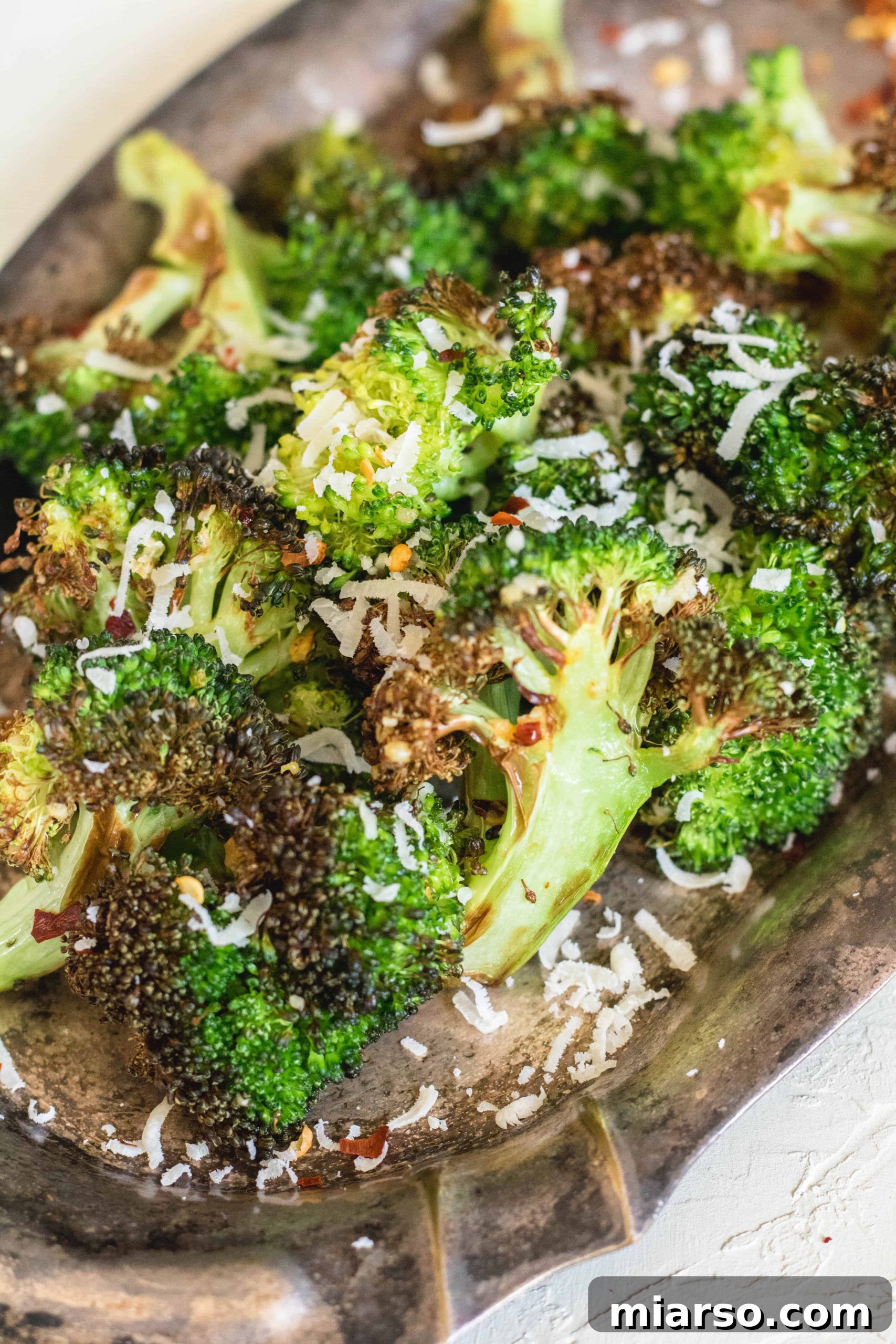 Easy and healthy air fried broccoli with a sprinkle of parmesan