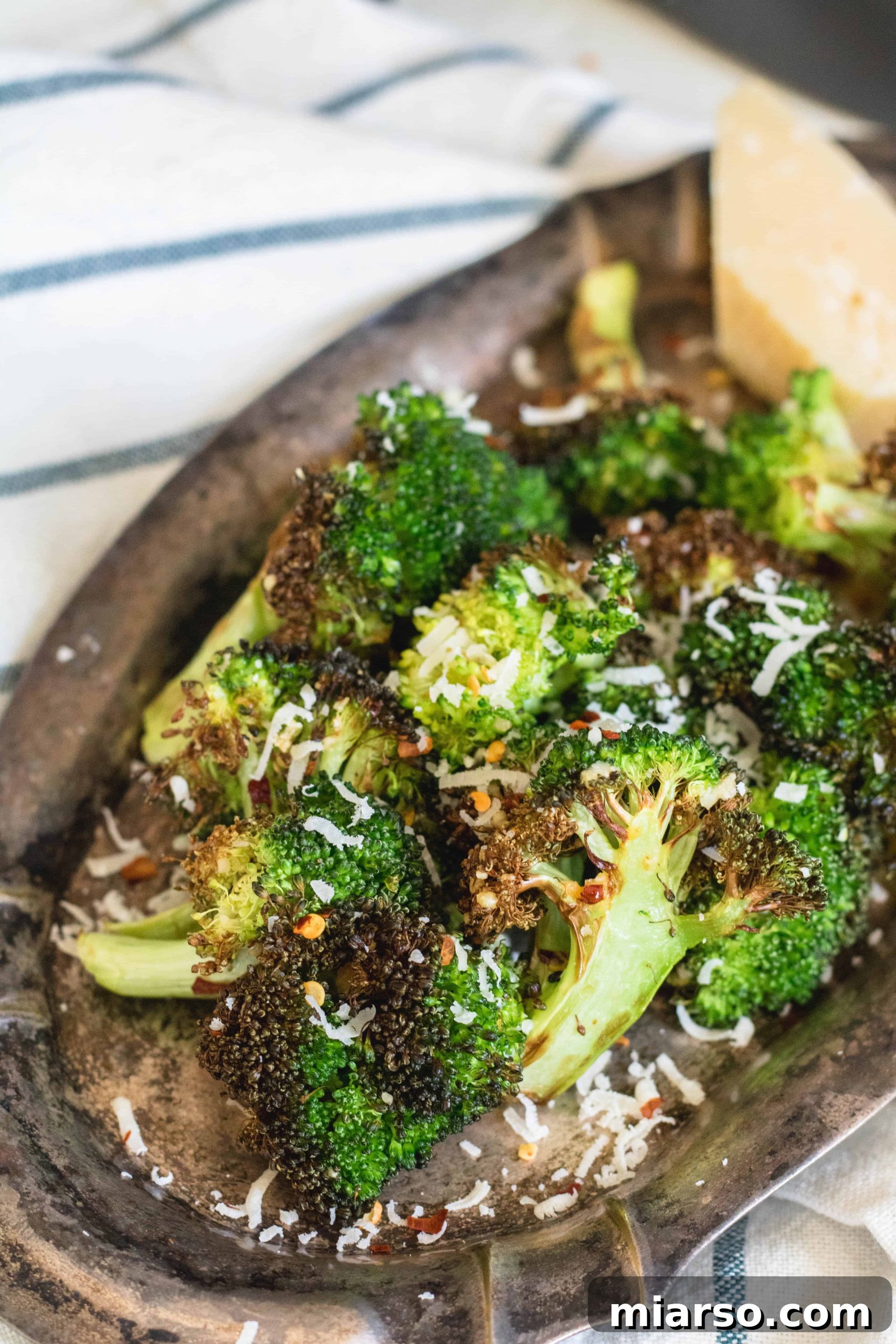 Air fryer broccoli ready to be seasoned in a bowl