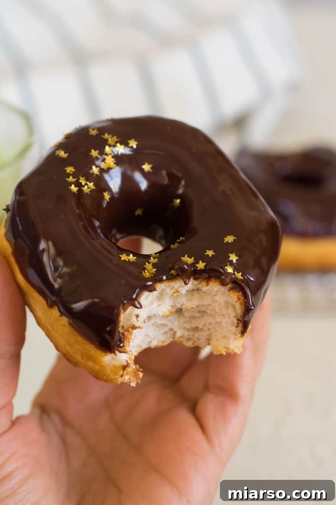 Biscuit air fryer donut recipe, drizzled with chocolate glaze