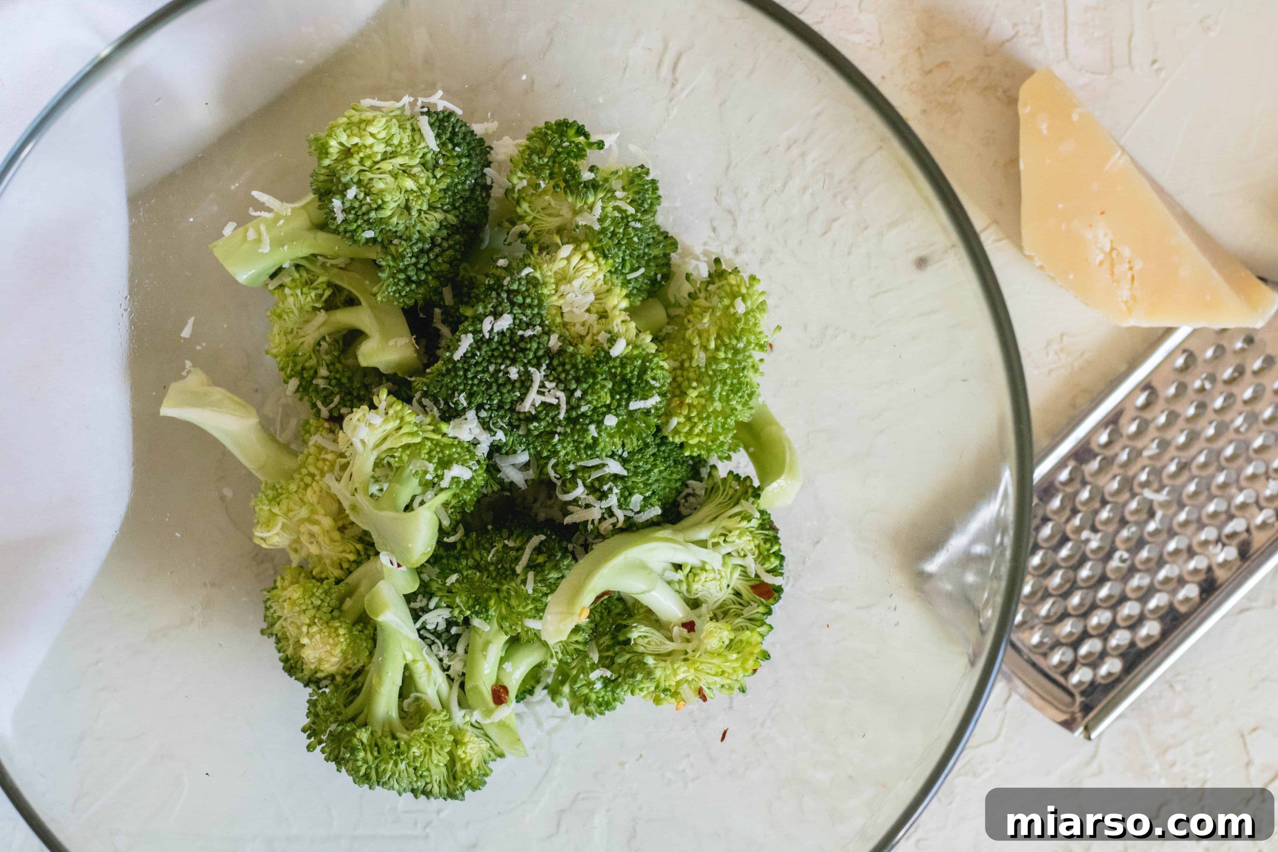 Air fryer broccoli with parmesan, freshly grated and steaming hot